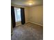 Cozy bedroom with plush carpet and natural light at 11811 E Maplewood Ave, Englewood, CO 80111