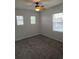 Bedroom featuring neutral walls, carpet, and natural light from three windows at 11811 E Maplewood Ave, Englewood, CO 80111