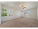 Bright bedroom with three large windows, neutral paint and plush carpeting at 11811 E Maplewood Ave, Englewood, CO 80111