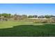 Expansive community green space with walking path and distant homes at 11811 E Maplewood Ave, Englewood, CO 80111