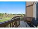 Private deck with wooden railings and views of a green lawn and nearby homes at 11811 E Maplewood Ave, Englewood, CO 80111