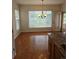 Bright dining area features hardwood floors, a modern chandelier, and sliding door access to outdoor at 11811 E Maplewood Ave, Englewood, CO 80111