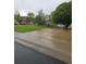 Long driveway leading to a home, surrounded by green lawns and mature trees in a quiet neighborhood at 11811 E Maplewood Ave, Englewood, CO 80111