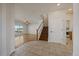 Inviting entryway with tile flooring, stairs, and a bright view into the adjacent living room at 11811 E Maplewood Ave, Englewood, CO 80111