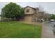 Inviting two-story home with a well-manicured lawn, attached garage, and mature trees at 11811 E Maplewood Ave, Englewood, CO 80111
