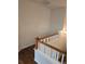 A well-lit staircase with white railings and wood trim accents at 11811 E Maplewood Ave, Englewood, CO 80111