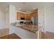Updated kitchen boasting granite counters, stainless appliances, and ample natural light at 11811 E Maplewood Ave, Englewood, CO 80111
