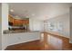 Modern kitchen with granite countertops, stainless steel appliances, and natural wood cabinetry at 11811 E Maplewood Ave, Englewood, CO 80111