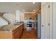 A well-equipped kitchen featuring stainless steel appliances, granite countertops, and wood cabinetry at 11811 E Maplewood Ave, Englewood, CO 80111