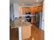 Modern kitchen boasts stainless steel appliances, granite countertops, and beautiful wood cabinets at 11811 E Maplewood Ave, Englewood, CO 80111