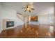 Bright, open-concept living space with a fireplace, staircase, and direct access to the kitchen at 11811 E Maplewood Ave, Englewood, CO 80111