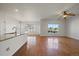 Sunlit living room with hardwood floors, open layout, and a view of the deck at 11811 E Maplewood Ave, Englewood, CO 80111