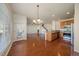 Open floor plan featuring a dining area, fireplace and hardwood floors throughout the main level at 11811 E Maplewood Ave, Englewood, CO 80111