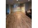 Finished basement area with wood-look floors, storage, and plenty of open space at 11811 E Maplewood Ave, Englewood, CO 80111