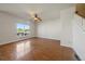 Spacious living room featuring hardwood floors, bright natural light, and staircase access at 11811 E Maplewood Ave, Englewood, CO 80111