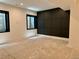 Basement featuring black framed egress windows offering natural light, and a black accent wall at 2442 S Saint Paul St, Denver, CO 80210