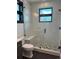 Sleek bathroom with glass shower, black framed window, and modern fixtures at 2442 S Saint Paul St, Denver, CO 80210