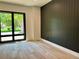 Bright bedroom boasts a large window, hardwood floors, and a modern accent wall at 2442 S Saint Paul St, Denver, CO 80210
