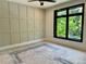 Bright bedroom featuring custom grid accent wall and large window at 2442 S Saint Paul St, Denver, CO 80210