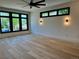 Bedroom featuring hardwood floors, recessed lighting, sconces, and black frame windows at 2442 S Saint Paul St, Denver, CO 80210