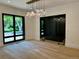 Elegant dining room with large windows, hardwood floors, and a stunning, modern chandelier at 2442 S Saint Paul St, Denver, CO 80210