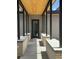 Modern entryway with wood and metal awning and concrete walkway at 2442 S Saint Paul St, Denver, CO 80210