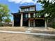 Modern two story home features brick accents, black trim, and a covered front porch at 2442 S Saint Paul St, Denver, CO 80210