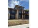 Modern two-story home showcasing a mix of brick and siding with large windows and stylish black accents at 2442 S Saint Paul St, Denver, CO 80210