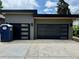 Modern two-car garage with black doors featuring windows and black trim at 2442 S Saint Paul St, Denver, CO 80210