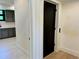 Hallway featuring white trim and black solid core door at 2442 S Saint Paul St, Denver, CO 80210