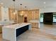 Bright, open kitchen with a waterfall island, custom cabinets, and stylish pendant lighting at 2442 S Saint Paul St, Denver, CO 80210