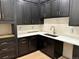 Modern kitchen features dark cabinetry, gold hardware, quartz countertops and stainless steel sink at 2442 S Saint Paul St, Denver, CO 80210