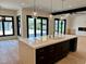 Open kitchen concept with a large island, pendant lighting, and stainless steel faucet at 2442 S Saint Paul St, Denver, CO 80210