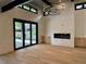 A living room with a fireplace, hardwood floors, a large sliding door, and natural light at 2442 S Saint Paul St, Denver, CO 80210