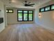 Spacious living room featuring hardwood floors, a modern ceiling fan, and lots of natural light at 2442 S Saint Paul St, Denver, CO 80210