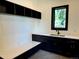 Mudroom featuring dark cabinetry, quartz countertops, a utility sink, and a built-in bench at 2442 S Saint Paul St, Denver, CO 80210