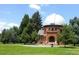 Exterior view of the historic Chamberlin Observatory nestled among trees on a sunny day at 2442 S Saint Paul St, Denver, CO 80210