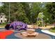 Fun playground featuring vibrant colors, unique play structures, and climbing rocks at 2442 S Saint Paul St, Denver, CO 80210