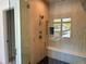 Walk-in shower featuring wood-look tile, a rainfall shower head, and a built-in bench at 2442 S Saint Paul St, Denver, CO 80210