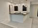 Basement wet bar featuring white marble flooring, a dark countertop, stylish pendant lights, and dark cabinets at 2442 S Saint Paul St, Denver, CO 80210