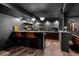 Finished basement with a modern bar featuring stylish lighting and hardwood floors at 5795 S Pagosa Way, Centennial, CO 80015