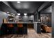 Finished basement features a stylish bar with seating and hardwood floors at 5795 S Pagosa Way, Centennial, CO 80015