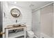 Bathroom features a modern sink and vanity, a toilet, and a glass-enclosed shower at 5795 S Pagosa Way, Centennial, CO 80015