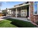 Relaxing covered patio with outdoor furniture and lighting, seamlessly blending indoor and outdoor living spaces at 5795 S Pagosa Way, Centennial, CO 80015