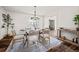Elegant dining room with hardwood floors, decorative molding, modern chandelier, and a sunlit window at 5795 S Pagosa Way, Centennial, CO 80015
