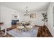 Elegant dining room with hardwood floors, decorative molding, modern chandelier, and views into the kitchen at 5795 S Pagosa Way, Centennial, CO 80015