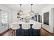 Modern kitchen boasts an island, quartz countertop, pendant lights, and white cabinetry at 5795 S Pagosa Way, Centennial, CO 80015