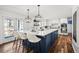 Spacious, modern kitchen with an island, quartz countertop, pendant lights, and stainless steel appliances at 5795 S Pagosa Way, Centennial, CO 80015