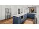 Large kitchen island with stainless steel appliances and rustic hardwood floors at 5795 S Pagosa Way, Centennial, CO 80015