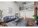 Spacious living room with vaulted ceiling, brick fireplace, hardwood floors, and open loft area at 5795 S Pagosa Way, Centennial, CO 80015